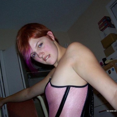 Redhead Pixie In A Pink Corset